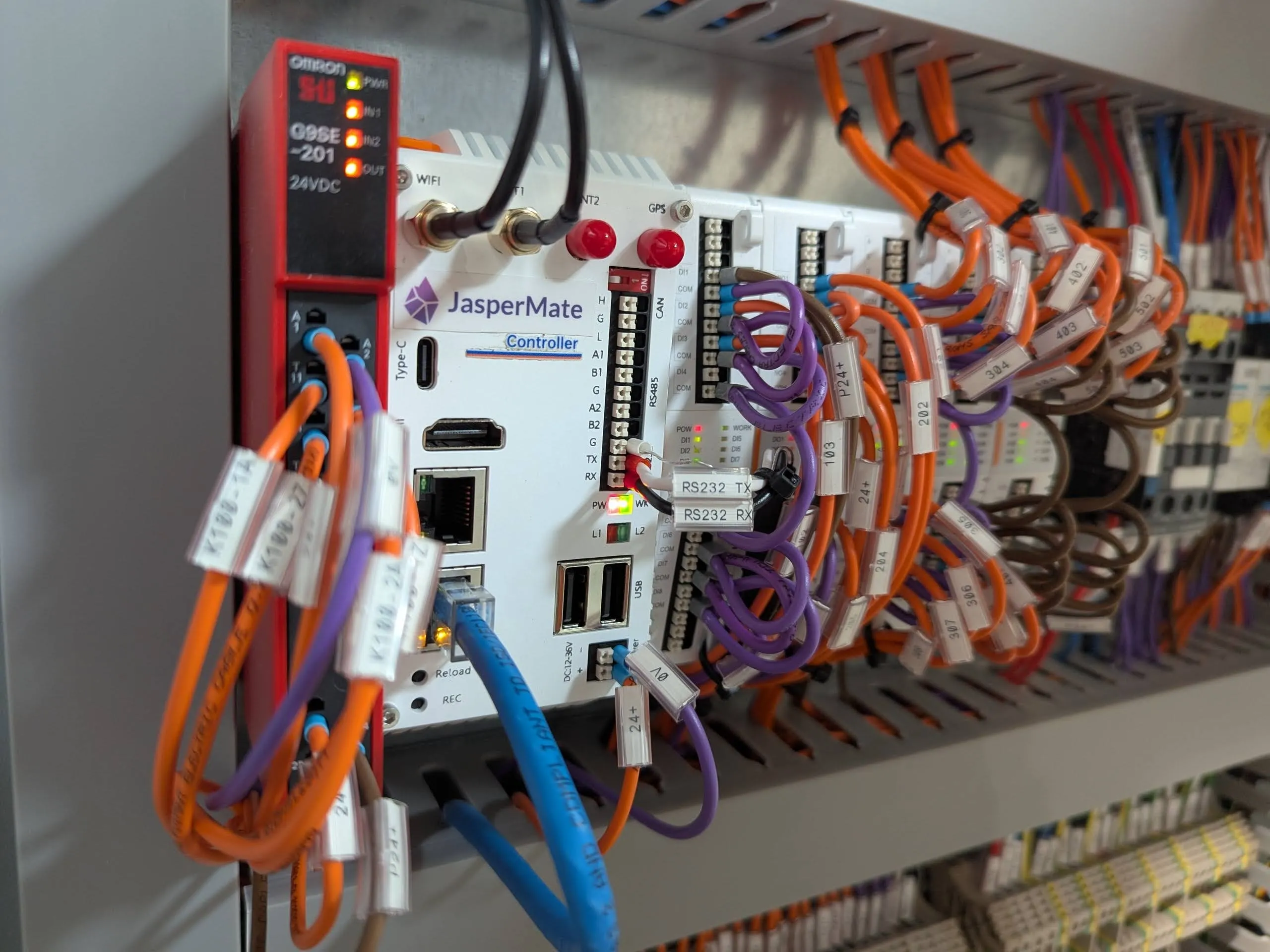 JasperMate controller with expansion cards installed in a wired control panel, running with labeled wiring